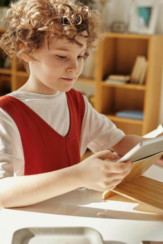 Young student using an ipad in classroom
