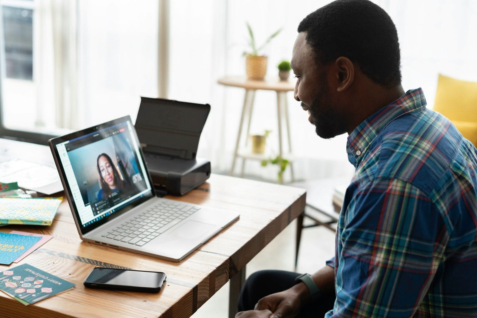 Man having a video call on his laptop with a woman